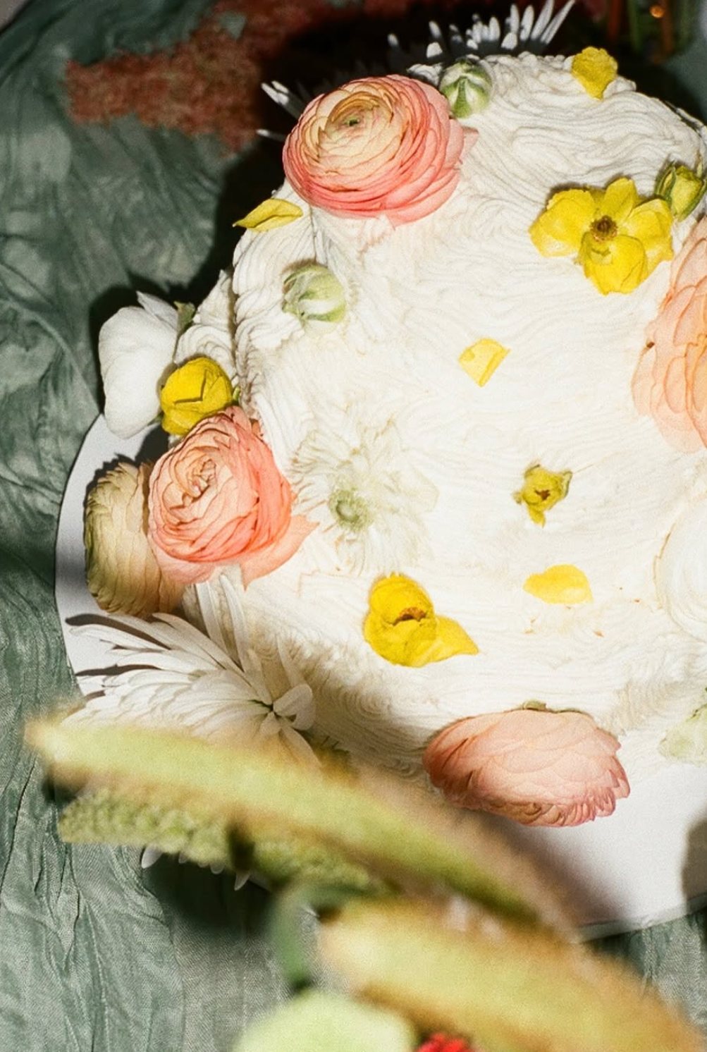 A cake dressed in fresh flowers