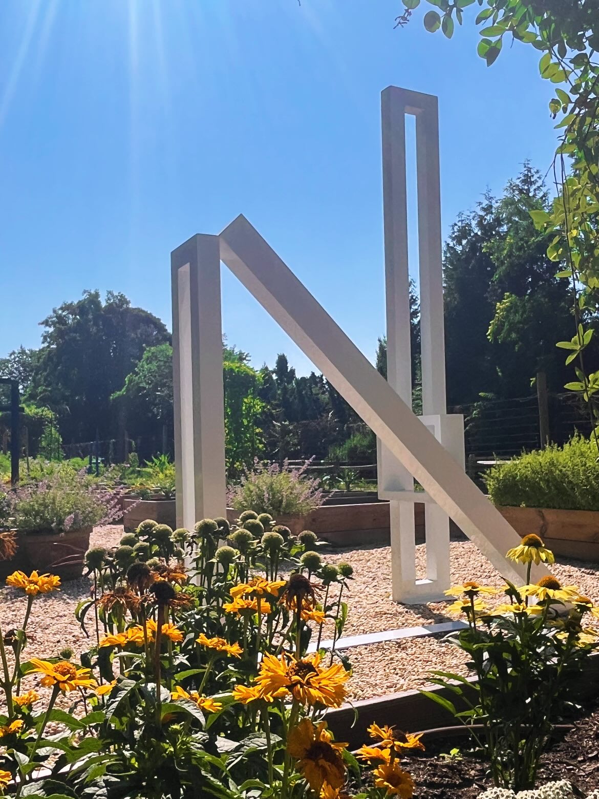 White steel sculpture among the beds